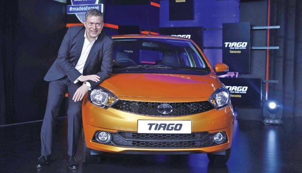 Guenter Butschek, Chief Executive Officer of Tata Motors Ltd, poses with a Tiago car during its launch in Mumbai yesterday.