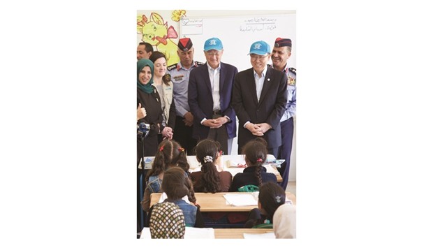 A handout picture provided by the UN refugee agency (UNHCR) shows UN chief Ban Ki-moon (right) and World Bank President Jim Yong Kim (centre) meeting with young Syrian refugees during a visit at the Zaatari refugee camp, located close to the northern Jordanian city of Mafraq near the border with Syria, last month.