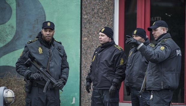 Danish police, in cooperation with the Police Intelligence Department, search an apartment block in Ishoej, south of Copenhagen, on Thursday.