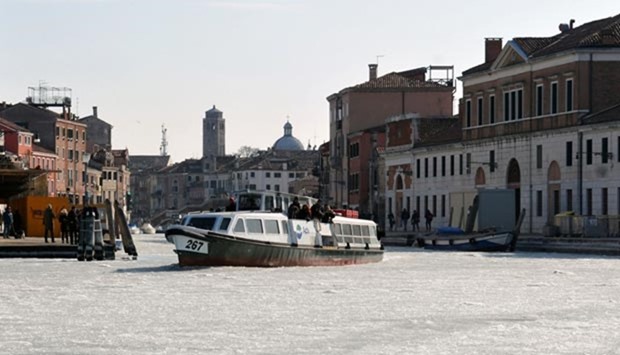 A vaporetto (water bus) passing on a canal covered with ice in Venice in this file photo.