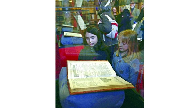 Visitors look at a Shakespeare First Folio discovered nearly 400 years after his death as it is displayed at Mount Stuart, Isle of Bute, Scotland, yesterday.