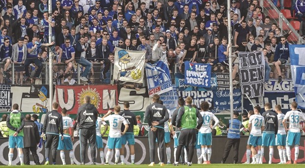 Angry Schalke fans insult players of the team after the German first division Bundesliga match against FC Ingolstadt in Ingolstadt, southern Germany, on April 2, 2016. Ingolstadt won the match 3-0. (AFP)
