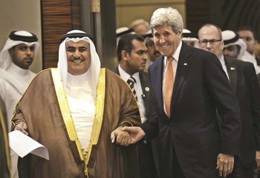 Bahrainu2019s Foreign Affairs Minister Sheikh Khaled bin Ahmed al-Khalifah and US Secretary of State John Kerry share a lighter moment ahead of a press conference in Manama.