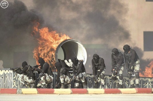 Members of Saudi security forces demonstrate their skills during a military exercise west of Riyadh.