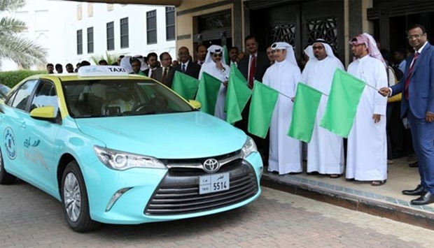 Abdulla al-Sabbagh and senior officials of Mowasalat flagging off the new taxis on Thursday: PICTURE: Jayaram.