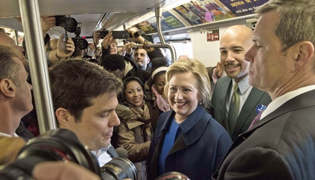 Clinton rides the No 4 train with borough president Ruben Diaz Jr as she campaigns yesterday in the Bronx borough of New York City.