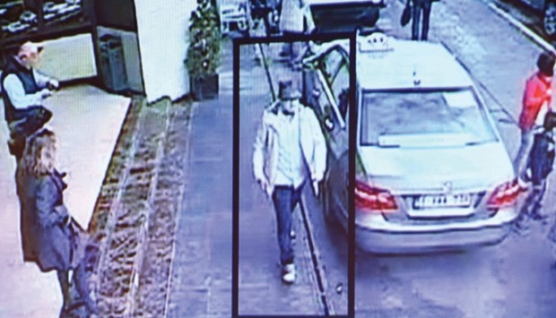 A photo taken during a press conference to present a police search notice for the third suspect from the Brussels airport attack shows a scene from video footage of the suspect leaving the site of the attack.