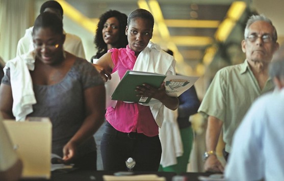 People looking for work stand in line to apply for jobs during a fair at the Miami Dolphins Sun Life stadium in Miami, Florida (file). Initial claims for state unemployment benefits declined 9,000 to a seasonally adjusted 267,000 for the week ended April 2, the Labour Department said yesterday.