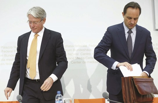Swiss Financial Market Supervisory Authority FINMA chief executive Mark Branson (right) and chairman Thomas Bauer arrive for a news conference in Bern, Switzerland yesterday. Branches of Swiss lenders including UBS and Credit Suisse were mentioned in the leaked documents as being among the main banks that requested the most offshore companies for clients.