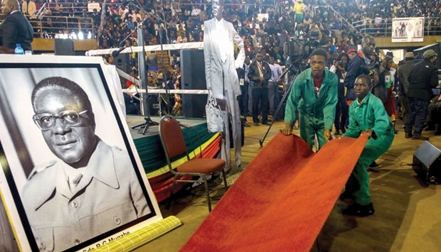 Workers preparing the red carpet ahead of a meeting last night between Mugabe and the Zimbabwe National Liberation War Veterans Association in Harare.