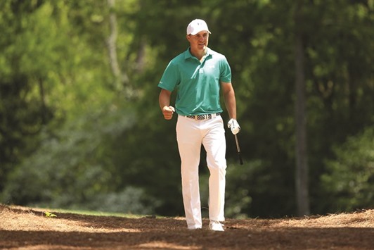 Jordan Spieth of the United States reacts after playing his second shot on the 11th hole during the first round of the 2016 Masters Tournament yesterday.