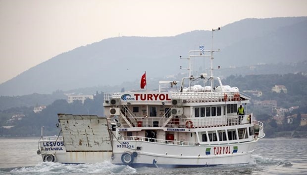 A Turkish-flagged passenger boat carrying migrants to be returned to Turkey leaves the port of Mytilene on the Greek island of Lesbos, on Friday.
