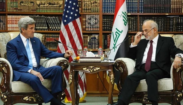 Iraq's Foreign Minister Ibrahim al-Jaafari receives US Secretary of State John Kerry in Baghdad on Friday.