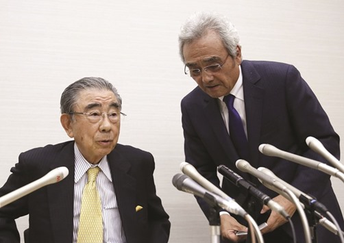 Toshifumi Suzuki (left), outgoing chairman and chief executive officer of Seven & i Holdings and president and chief operating officer Noritoshi Murata prepare to leave a news conference in Tokyo on Thursday.