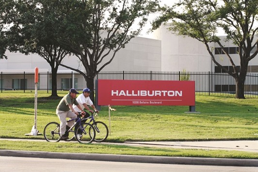 A pair of bicyclists ride past Halliburtonu2019s Energy Services Group, headquartered in west Houston. US enforcers have turned increasingly aggressive in their mission to protect competition between companies u2014 the latest example being the Justice Departmentu2019s expected move to block Halliburton Cou2019s takeover of rival oil-services company Baker Hughes.