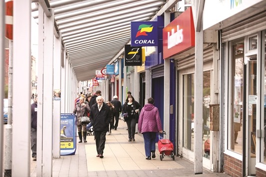 Shoppers pass along a pedestrianised shopping mall in Port Talbot, the UK. Britainu2019s industrial output shrank at the fastest rate in more than three years in the three months to February and the trade deficit ballooned to its widest in eight years, data showed yesterday.