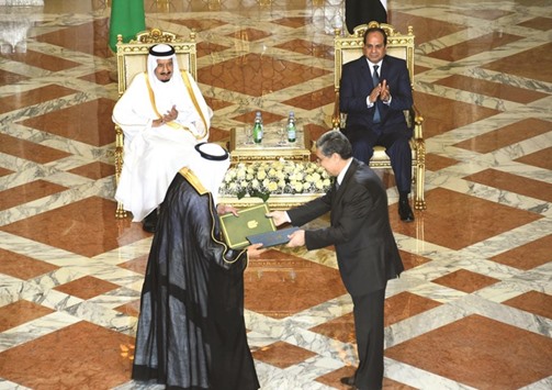 A handout picture released by the Egyptian Presidency yesterday shows Egyptian President Abdel Fattah al-Sisi and Saudi King Salman bin Abdulaziz applauding during a signing ceremony of bilateral agreements at the Presidential Palace in Cairo.