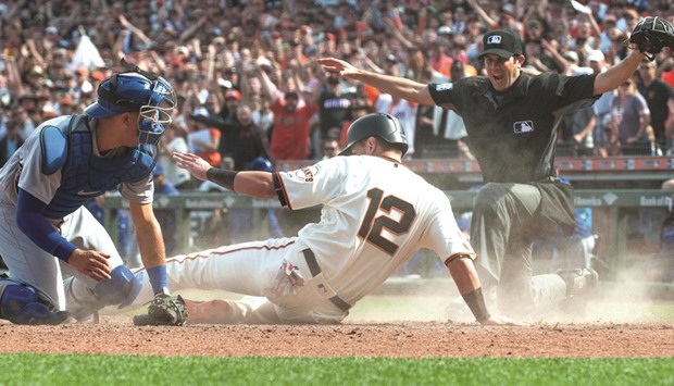 San Francisco Giants second baseman Joe Panik (12) is called safe at the plate during the sixth inning against the Los Angeles Dodgers at AT&T Park. Picture: Ed Szczepanski-USA TODAY Sports