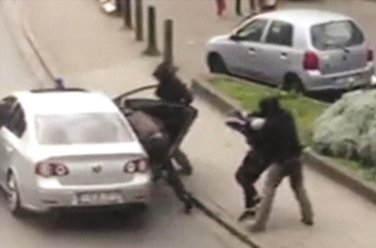 Police officers detain a suspect during a raid in which fugitive Mohamed Abrini was arrested in Anderlecht, near Brussels yesterday in this still image taken from video.