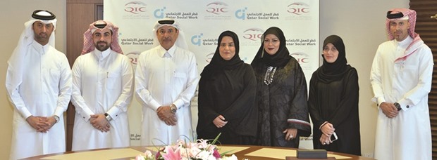 QIC and QFSW officials during the signing ceremony.