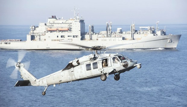 An MH-60S Sea Hawk helicopter prepares to land on the flight deck of aircraft carrier USS Harry S Truman during a vertical replenishment in the Arabian Gulf. The US Navy is leading a 30-nation maritime exercise across Middle Eastern waters which it says will help protect international trade routes against possible threats, including from Islamic State and Al Qaeda.