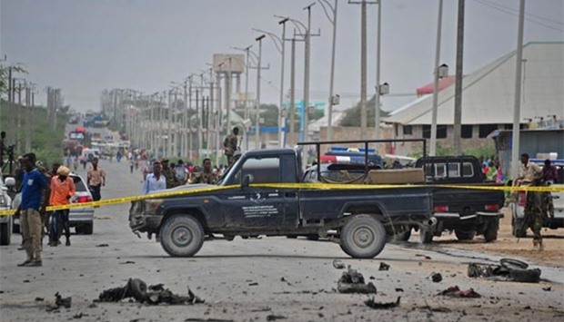 Security forces and residents gather at the scene of a suicide car attack in Mogadishu on Sunday.