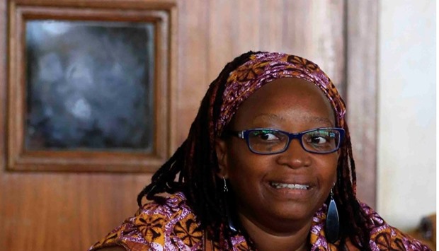 Ugandan prominent academic Stella Nyanzi smiles as she stands in the dock at Buganda Road Court for criticising the wife of President Yoweri Museveni on social media, in Kampala.
