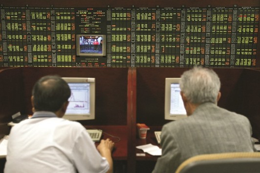 Investors monitor stock prices in Seoul. The Kospi index was the biggest decliner in Asia yesterday, falling the most in more than five weeks as the won led losses among major and emerging-market currencies.