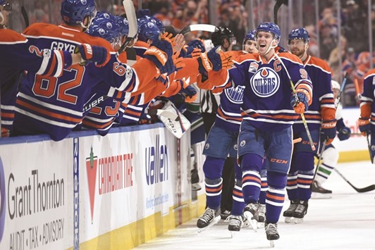Edmonton Oilers centre Connor McDavid (No 97) celebrates his 100th point of the season goal in the third period against the Vancouver Canucks at Rogers Place. The Oilers won 5-2. PICTURE: USA TODAY Sports
