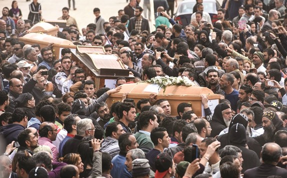 Mourners carry the coffins of the victims of the blast at the Coptic Christian Saint Marku2019s church in Alexandria during a funeral procession at the Monastery of Marmina in the city of Borg El-Arab, yesterday.
