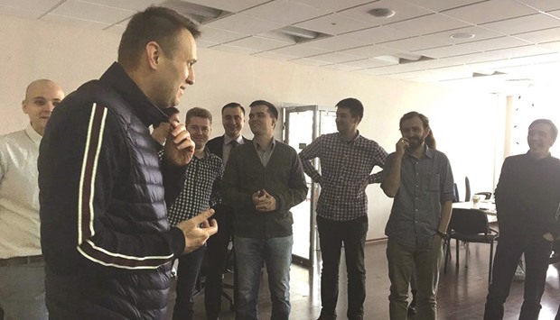 This handout picture obtained yesterday on Navalny supporter Leonid Volkovu2019s Twitter account shows Navalny speaking with employees at the offices of his anti-corruption foundation in Moscow.