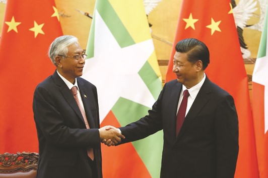 Chinau2019s President Xi Jinping shakes hands with Myanmaru2019s President Htin Kyaw at the Great Hall of People in Beijing yesterday.