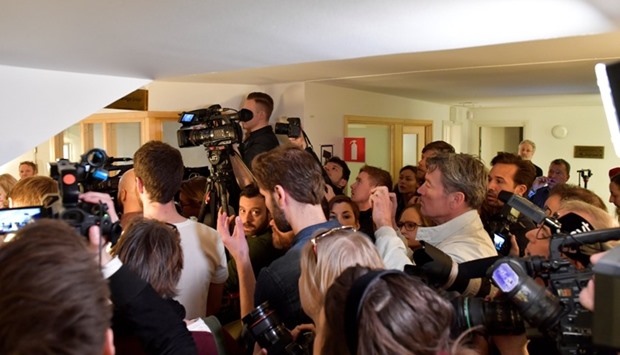 Journalists crowd the entrance to the Stockholm District Court at the remand hearings against Uzbek national Rakhmat Akilov, prime suspect in Friday's truck attack, in Stockholm.