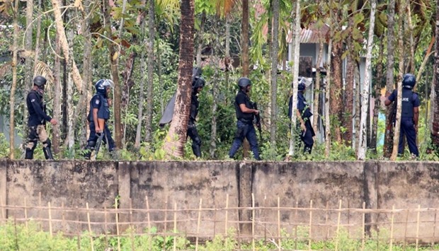 Security personnel get ready to raid a militant den in Nasirpur village, Dhaka