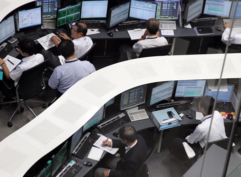 Employees work on the trading floor of the Tokyo Stock Exchange. The Nikkei 225 closed down 0.3% to 18,747.87 points yesterday.