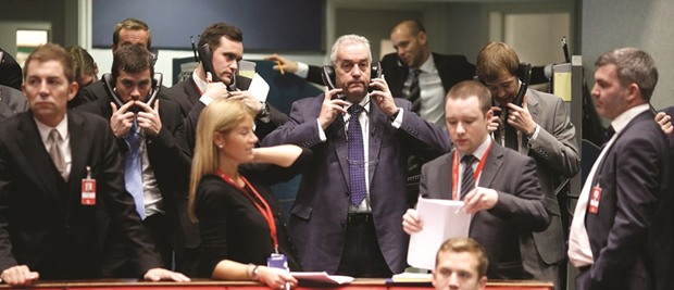 Traders use telephones as they work on the trading floor at the London Metal Exchange. The LME is considering reforming its complex structure of trading to lure funds and reverse falling volumes, laying bare a schism between those wanting change and core traditional members who do not.