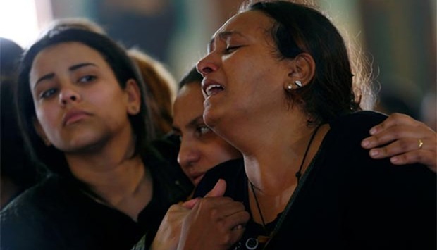 Relatives react as they mourn for the victims of the Palm Sunday bombings during their funeral at the Monastery of Saint Mina in Alexandria on Monday.