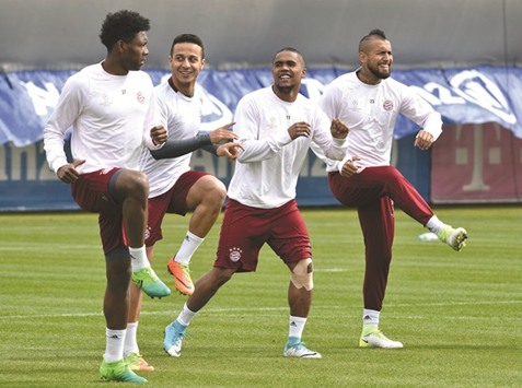 (from left) Bayern Munichu2019s David Alaba, Thiago Alcantara, Douglas Costa and Arturo Vidal attend a training session at the teamu2019s training grounds in Munich yesterday, on the eve of their UEFA Champions League quarter-final against Real Madrid. (AFP)