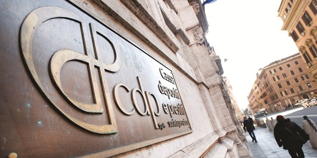 Pedestrians pass a Cassa Depositi e Prestiti (CDP) branch in Milan. Italy is studying a deal that would see CDP pay for the Treasury stakes by issuing preference shares that would then be sold to institutional investors, a source said.