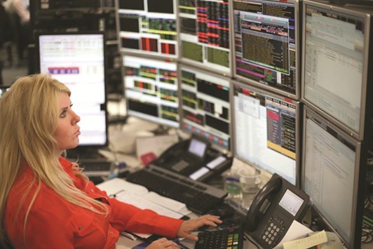 A trader works at the London Stock Exchange. The FTSE 100 climbed 0.2% to 7,365.50 yesterday.