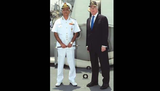 British Defence Minister Michael Fallon and Indian Flag Officer Commanding-in-Chief Western Naval Command Vice Admiral Girish Luthra pose for a photograph on board the Indian Naval ship Kolkata in Mumbai.