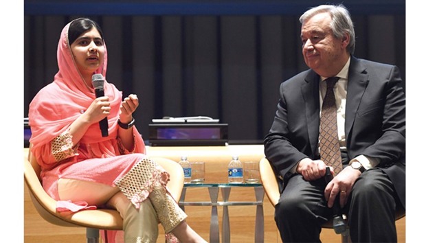 Nobel Peace Prize winner Malala Yousafzai (L) of Pakistan speaks as United Nations Secretary-General Antonio Guterres listens during a designation ceremony at the UN headquarters in New York on April 10, 2017. Yousafzai was designated as UN Messenger of Peace with a special focus on girlsu2019 education.