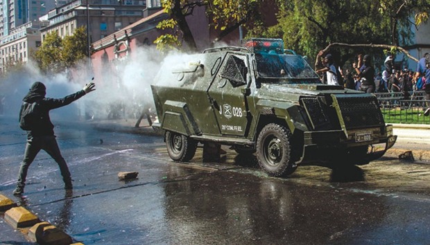 Students demanding the government to speed up a long-awaited reform to guarantee universal access to free public education in Chile are dispersed by the riot police with water cannons, in Santiago. Students have been appealing for the past decade to change the current system dating to the 1973-1990 dictatorship of Augusto Pinochet.