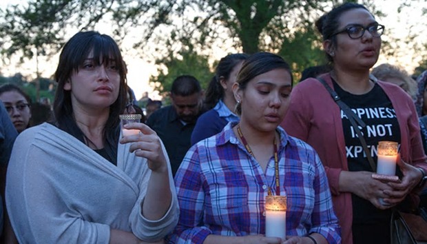 Attendees at a candlelight vigil at Our Lady of the Assumption church in San Bernardino, California, on Monday to mourn the victims of a deadly shooting at a local elementary school.