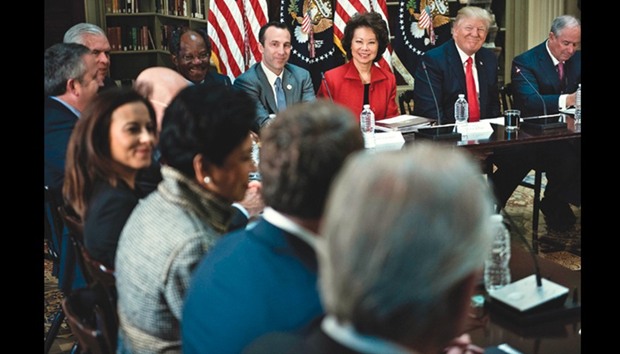 Secretary of Transportation Elaine Chao, President Donald Trump and Stephen A Schwarzman, CEO of the Blackstone Group, at a meeting with CEOs in the Eisenhower Executive Office Building on the White House campus.