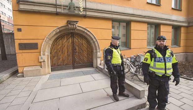 Officers secure the entrance to the Stockholm District Court where Akilov appeared for his hearing.
