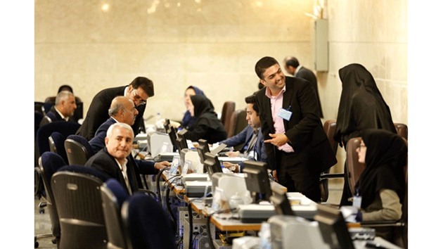 Iranians arrive to the Interior Ministryu2019s election headquarters as candidates begin to sign up for the upcoming presidential elections in Tehran yesterday.