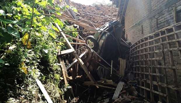 A trapped car and debris following a landslide that hit Banaran village in Ponorogo, East Java province.