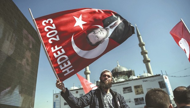 A man waves a flag with a portrait of Erdogan yesterday during a u2018Yesu2019 campaign event in Istanbulu2019s Eminonu district.