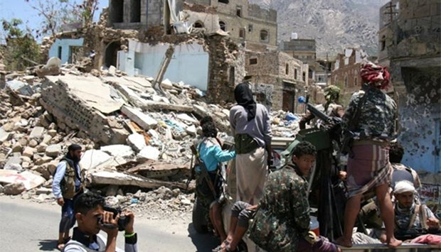 Pro-government tribal fighters patrol a street during a visit by a UN delegation in the Yemeni city of Taiz this week.